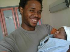 Glenn holding newborn Isaac on July 17 2014